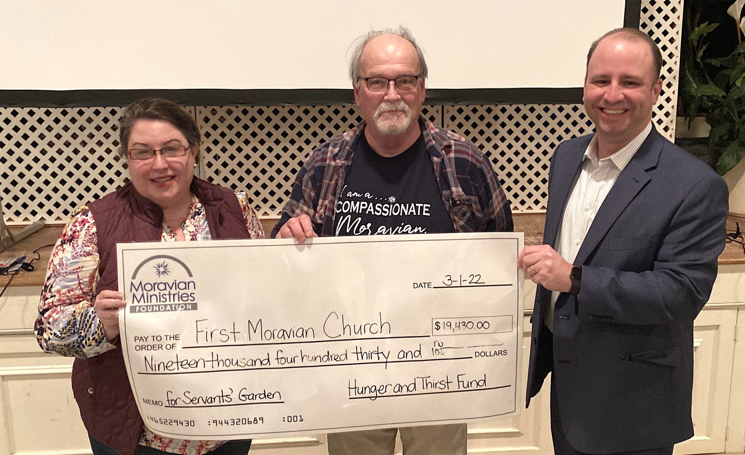 MMFA President/CEO Chris Spaugh (R) presents grant funds from the Hunger & Thirst Field of Interest Funds to Meredith Cohoon and Samuel Post, Jr. of First Moravian Church in Greensboro, NC.